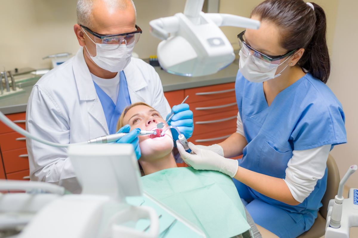 Dental assistant assisting a Dentist