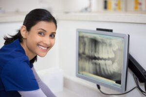 Dental assistant looking at xrays